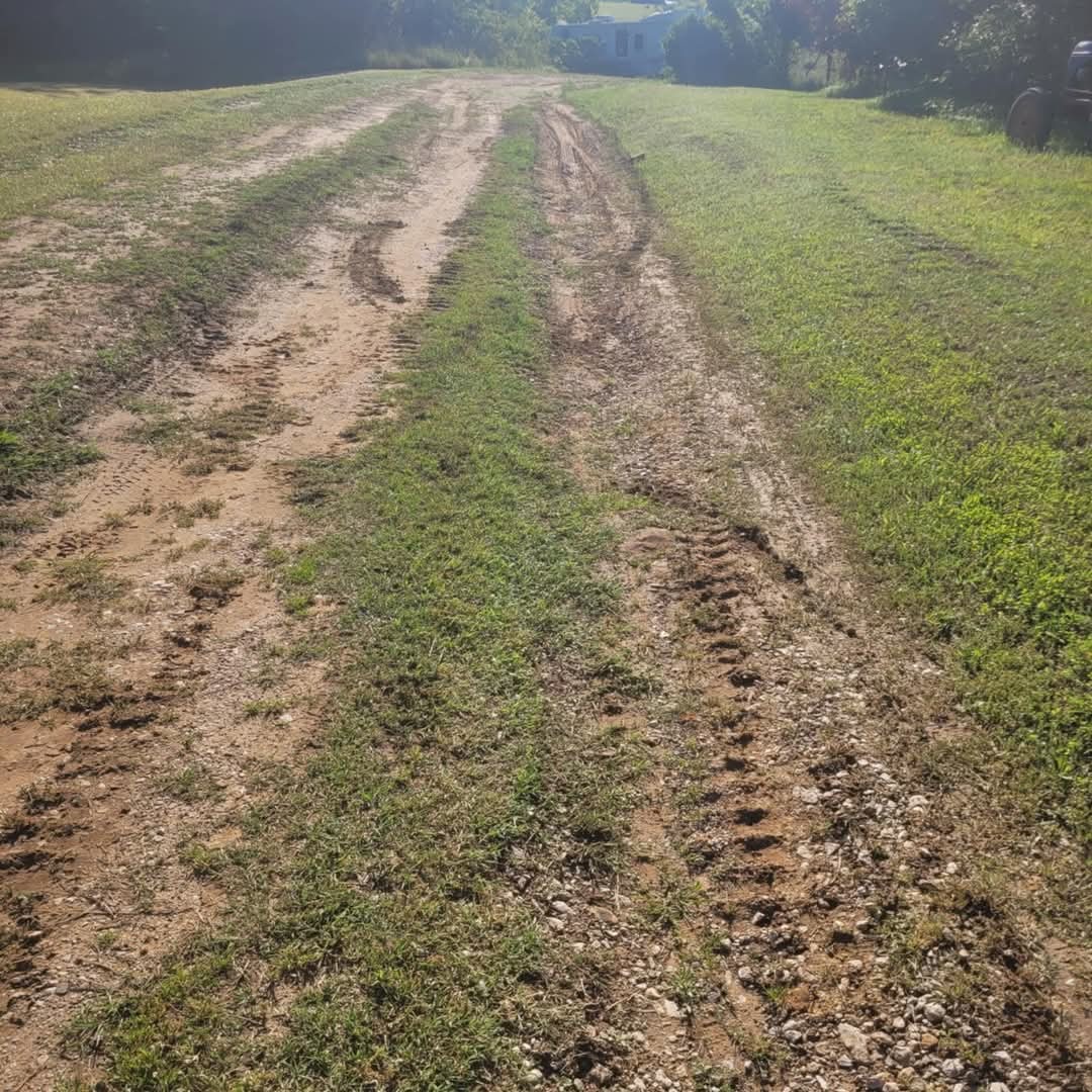 Rutted rural driveway before repair
